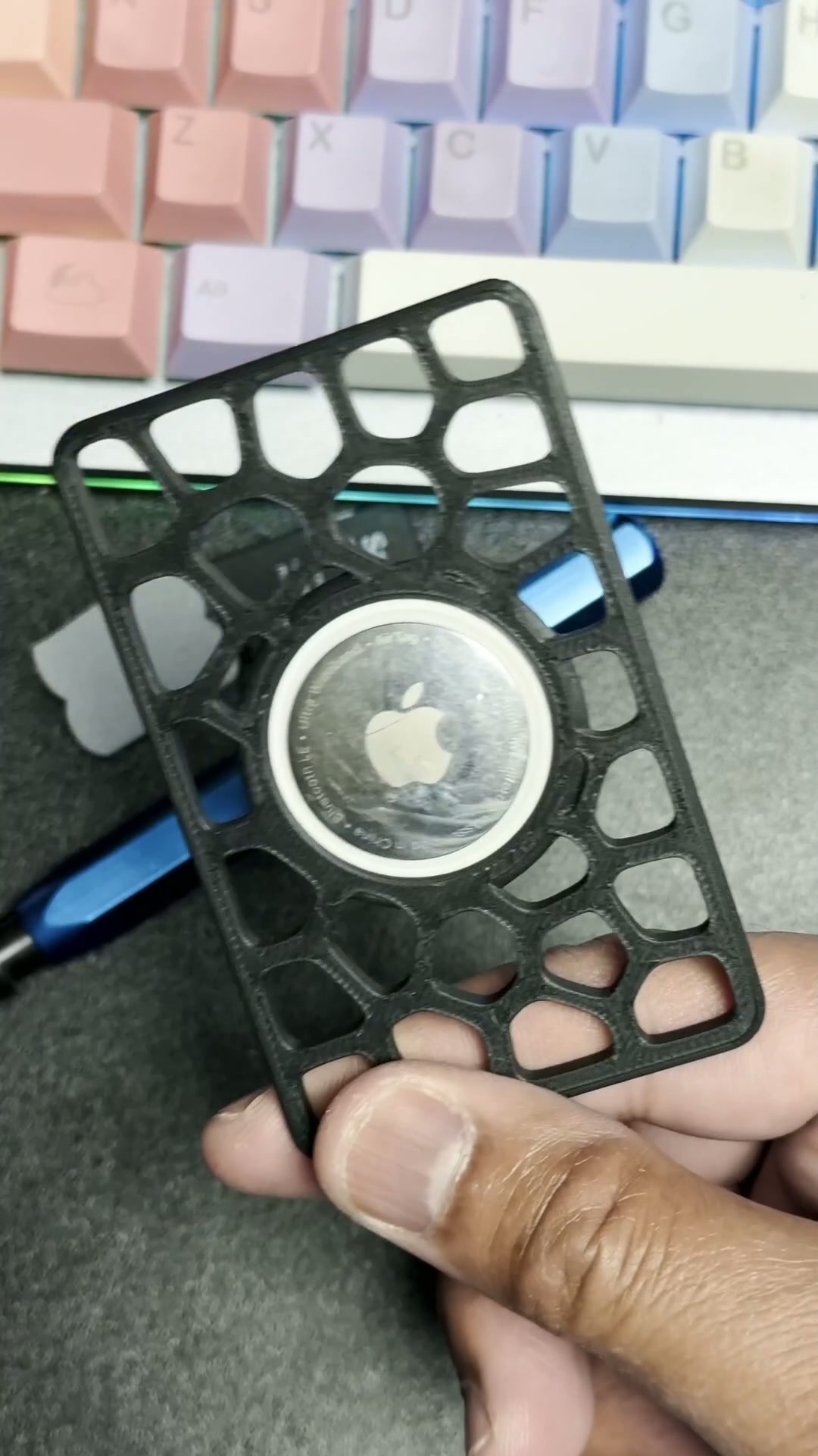 Apple AirTag seated in Bradley's black 3D-printed Voronoi wallet card